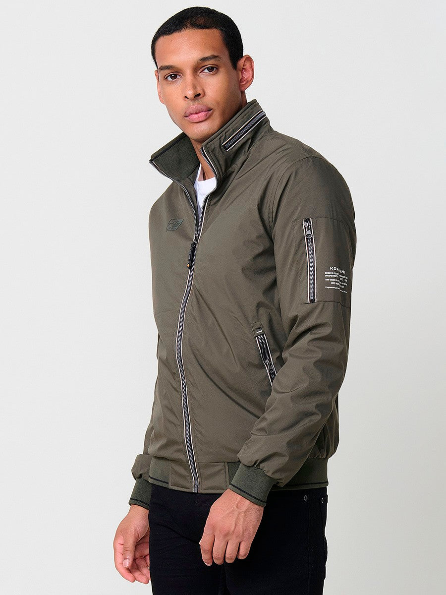 KORÖSHI. Cazadora de hombre en color kaki con cuello alto y cierre delantero con cremallera. Confeccionada en 100% poliéster.